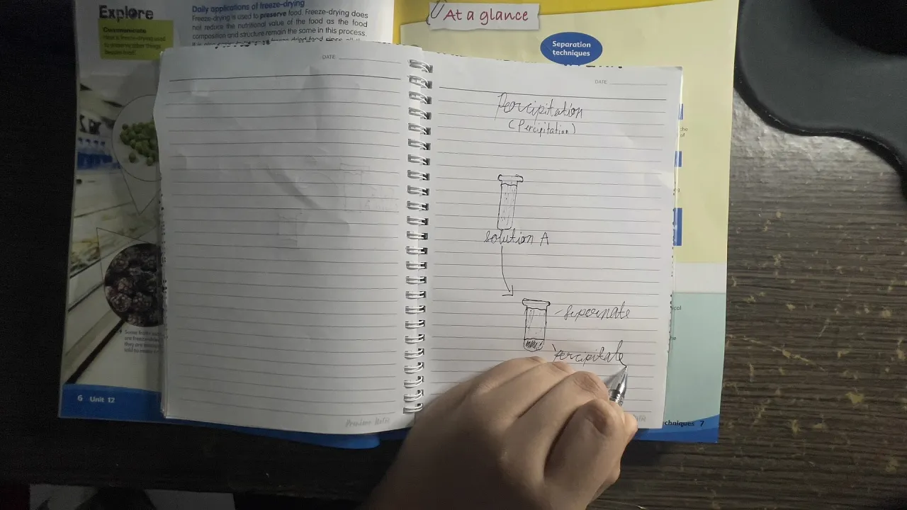 A learner writing in an open notebook
