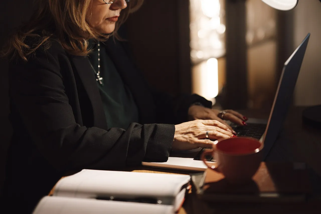 Adult learner working on laptop in home office