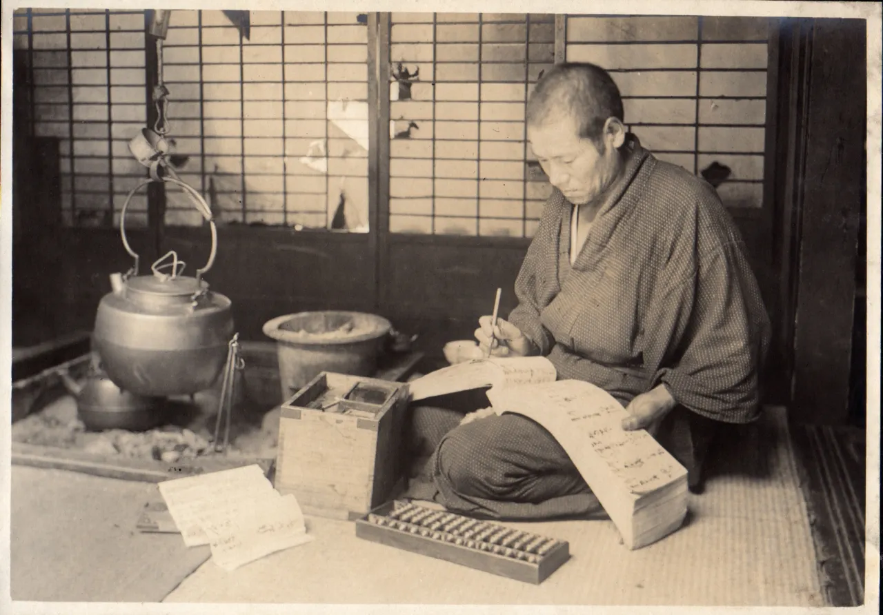 Historical accountant using an abacus and account book