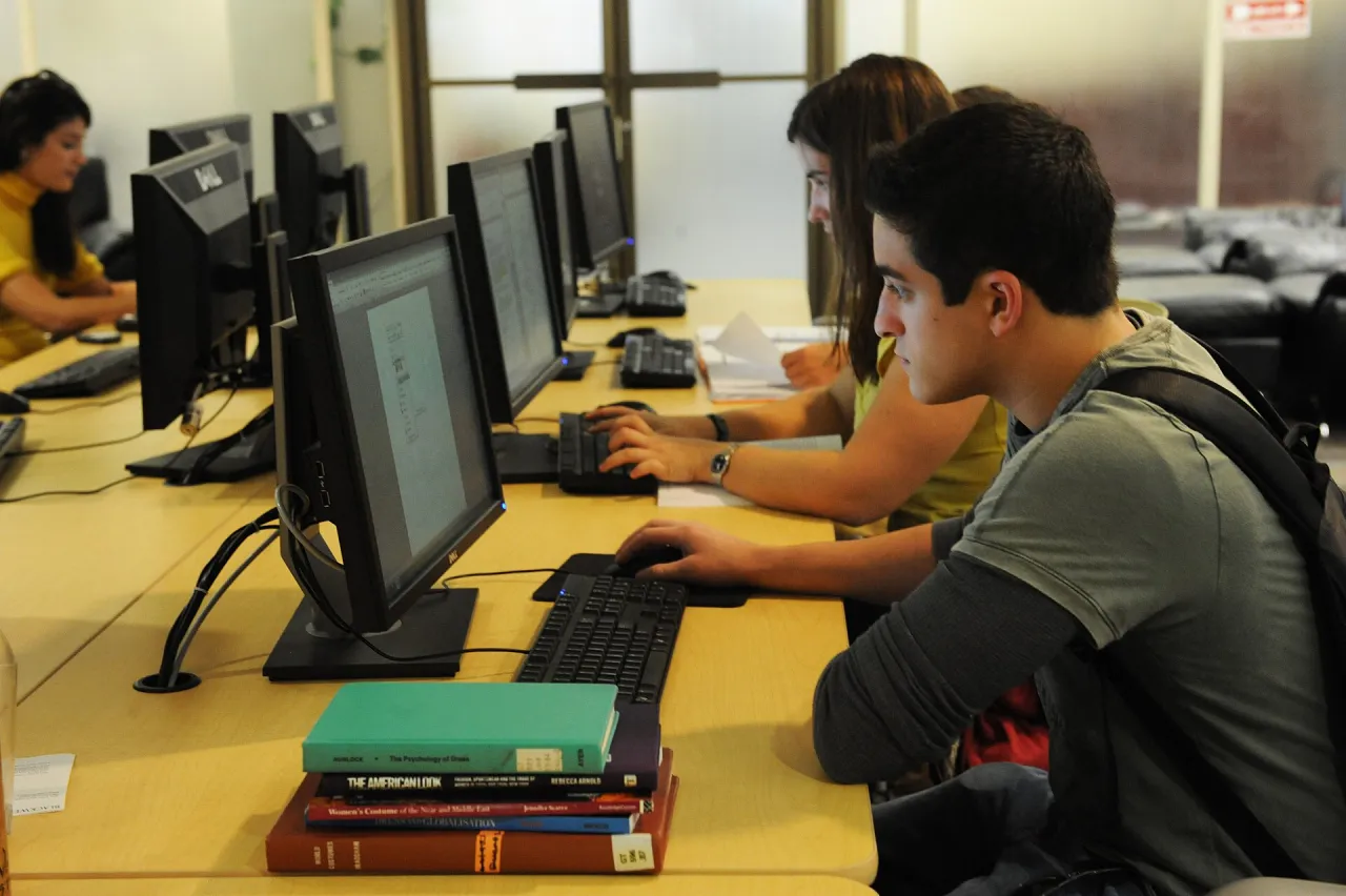 Students working at public library computers