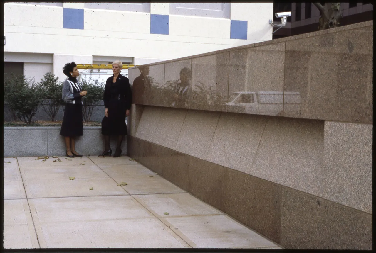 Two colleagues talking outside an office building